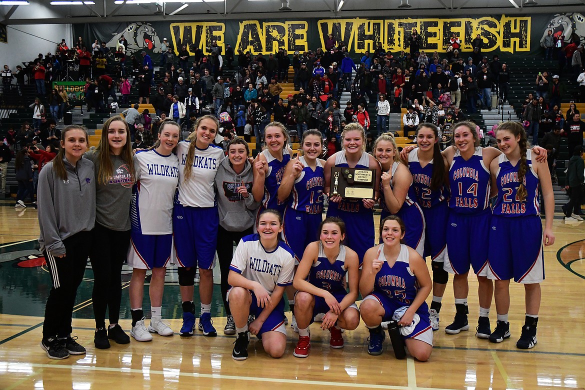 The Wildkats celebrate with the trophy after winning the Northwest A District Tournament Saturday. (Jeremy Weber photo)