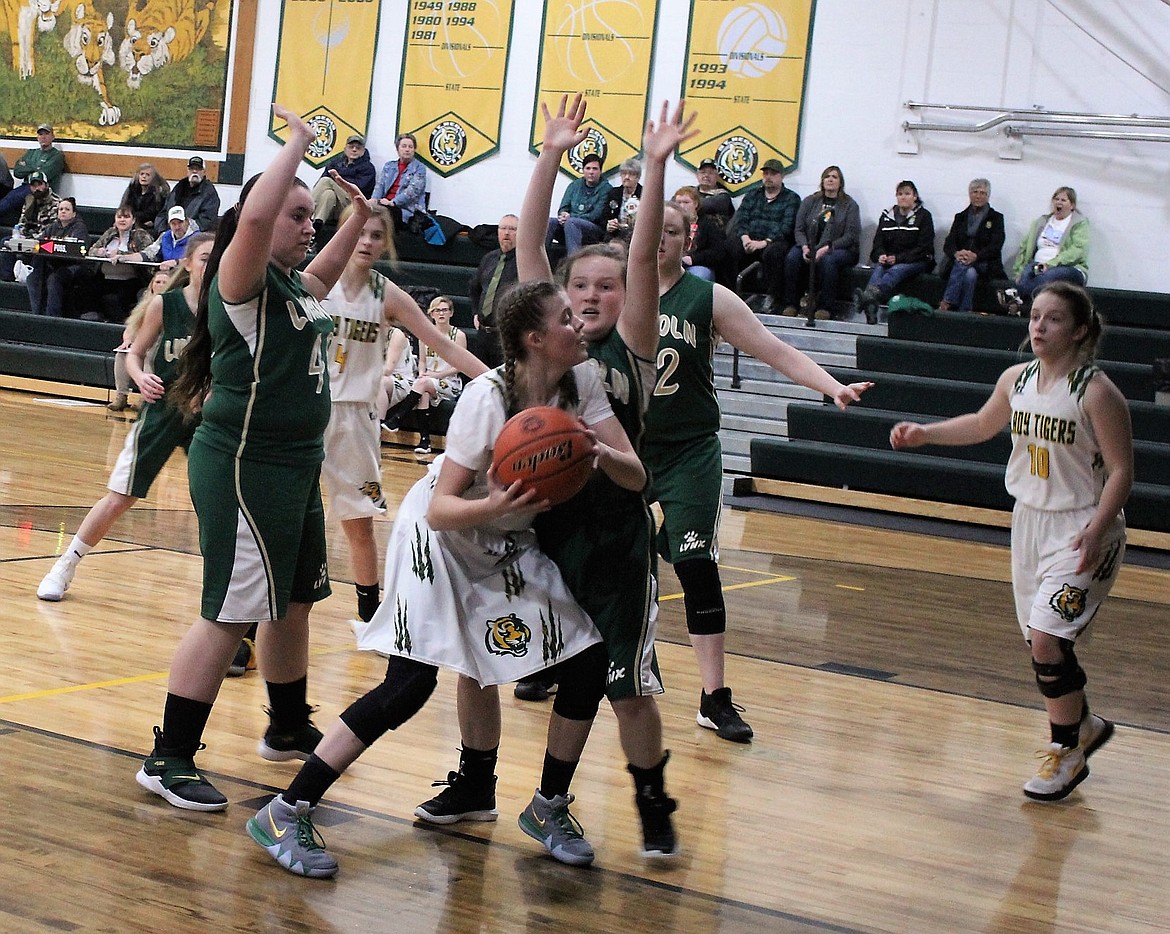 Graduating senior, Madison &#147;Mad-Dog&#148; Kelly, makes a layup past Lincoln players on Feb. 9 in St. Regis where the Tigers won, 48-24. (Kathleen Woodford/Mineral Independent).