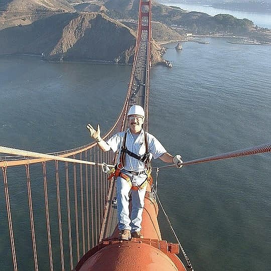 John Bebee stands high atop the Golden Gate Bridge in San Francisco during the mid 2000s. His chronic headaches ultimately ended his career as a steal inspector in 2007. (Photo courtesy John Bebee)