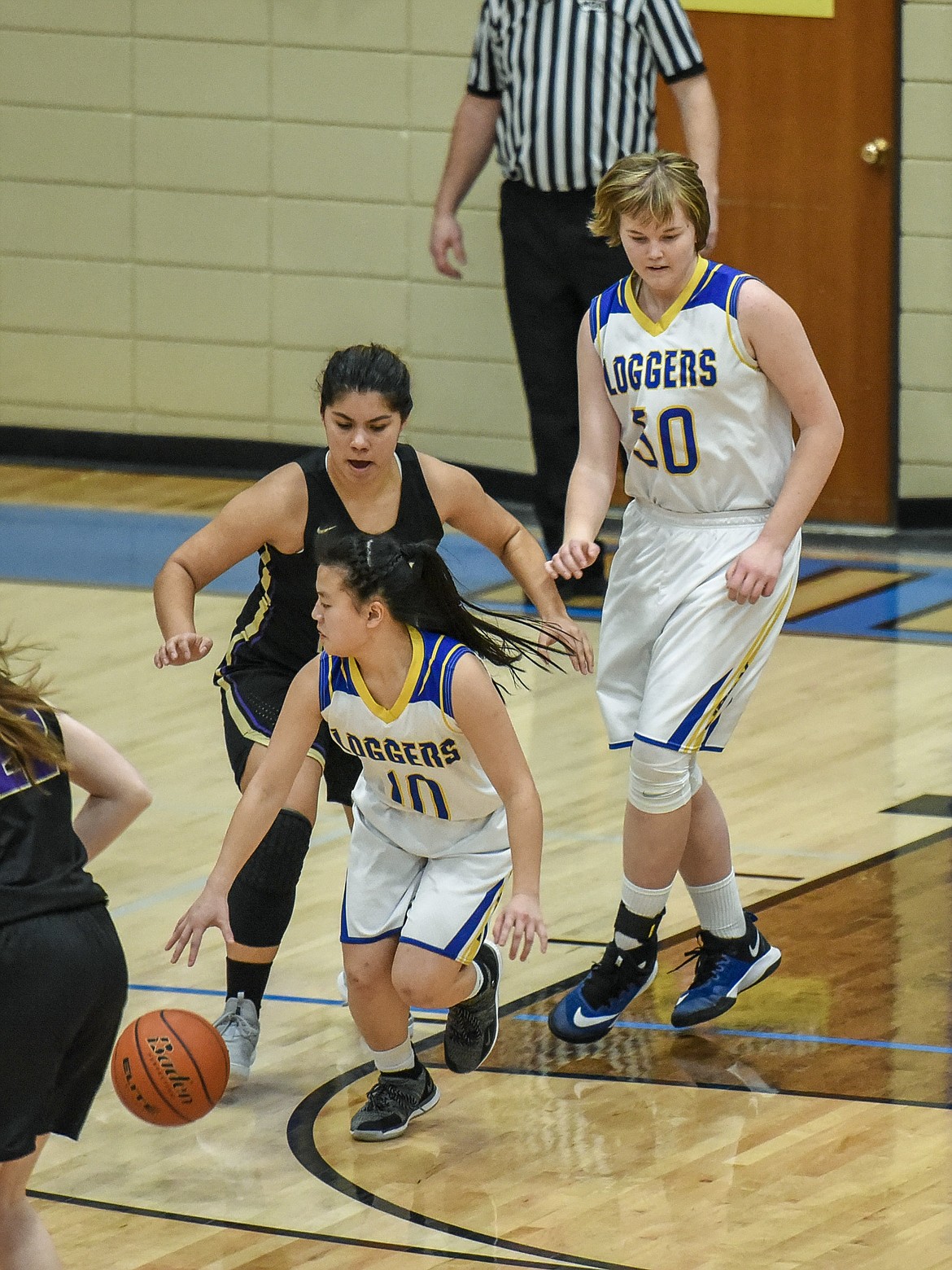 Libby junior Syd Gier grabs the ball Libby sophomore Taylor Holm knocked loose from Polson senior Olivia Perez late in the fourth quarter Saturday against Polson. (Ben Kibbey/The Western News)