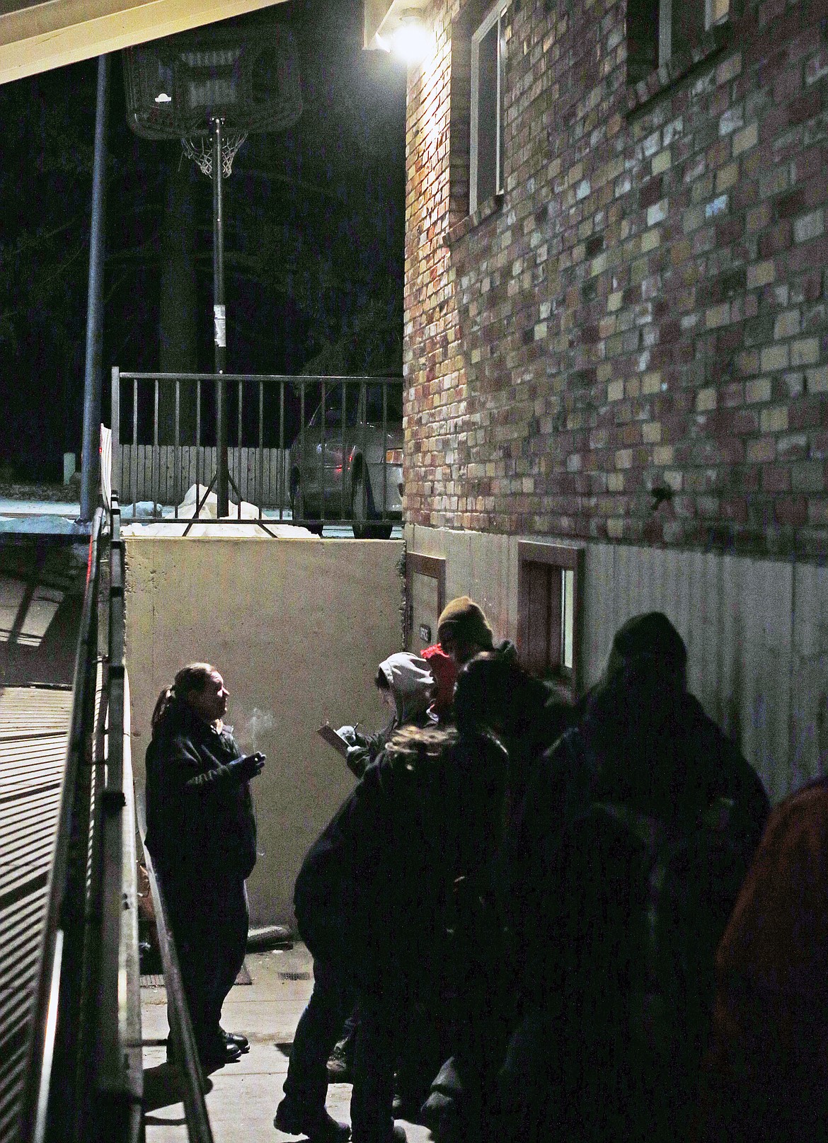 Folks wait outside the St. Vincent de Paul Warming Center before it opens for the evening last Wednesday. As the temperature continues to be 28 degrees and below, the center will remain open 7 p.m. to 7 a.m.