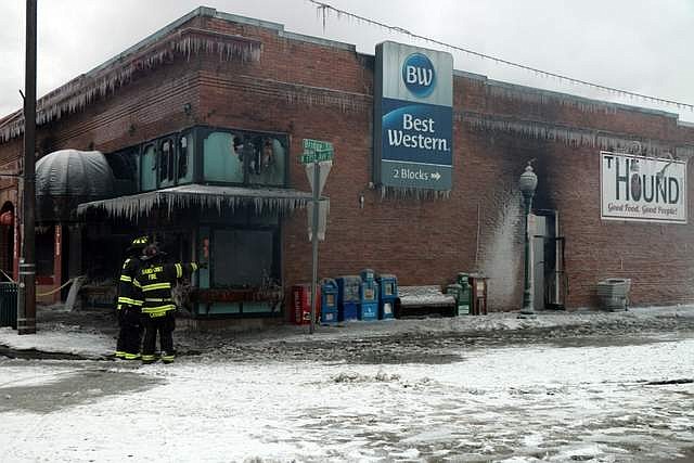 Photo by CAROLINE LOBSINGER
Area firefighters inspect the scene after after an early-morning fire Monday destroyed five businesses in Sandpoint&#146;s Historic District.