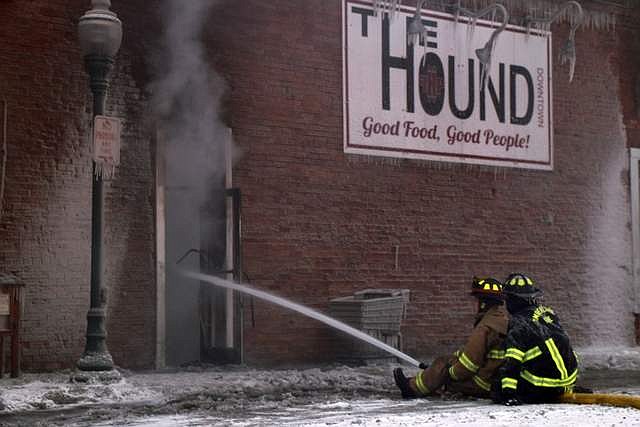 Area firefighters direct water into The Hound as they mop up at the scene of a Monday fire in Sandpoint&#146;s Historic District.

Photo by CAROLINE LOBSINGER