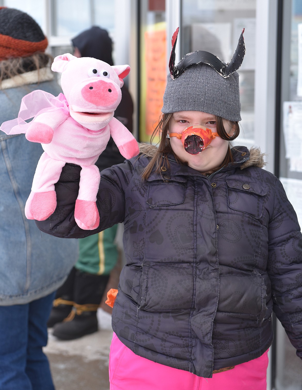 LOTI WHITWELL dressed for the occasion to march in the Chinese New Year Parade last Saturday, pig snout and pig puppet and all.