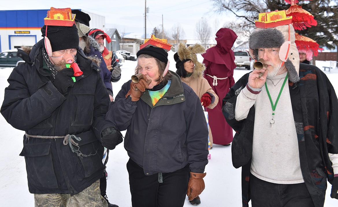 UNIDENTIFIED MEMBERS of the &quot;money kazoo band&quot; toot their horns in unison during the Chinese New Year Parade.