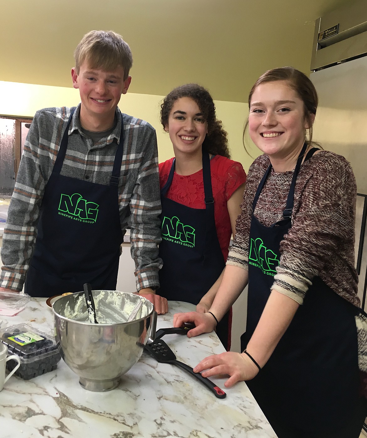 VETERANS OF the Charlo-Dixon art camp, Charlo High School seniors Wills DeGrandpre, Allison Delaney and Jaden Coston enjoy giving back by helping in the kitchen at the annual NAG fundraiser event.