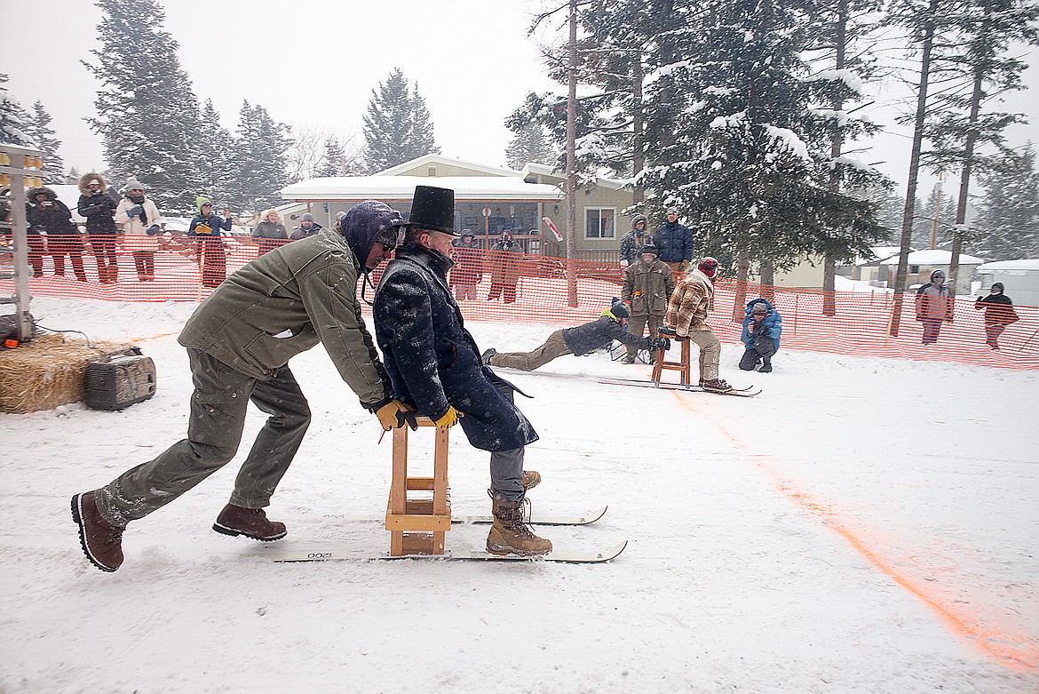 Steve Paugh, in top hat, get a push.