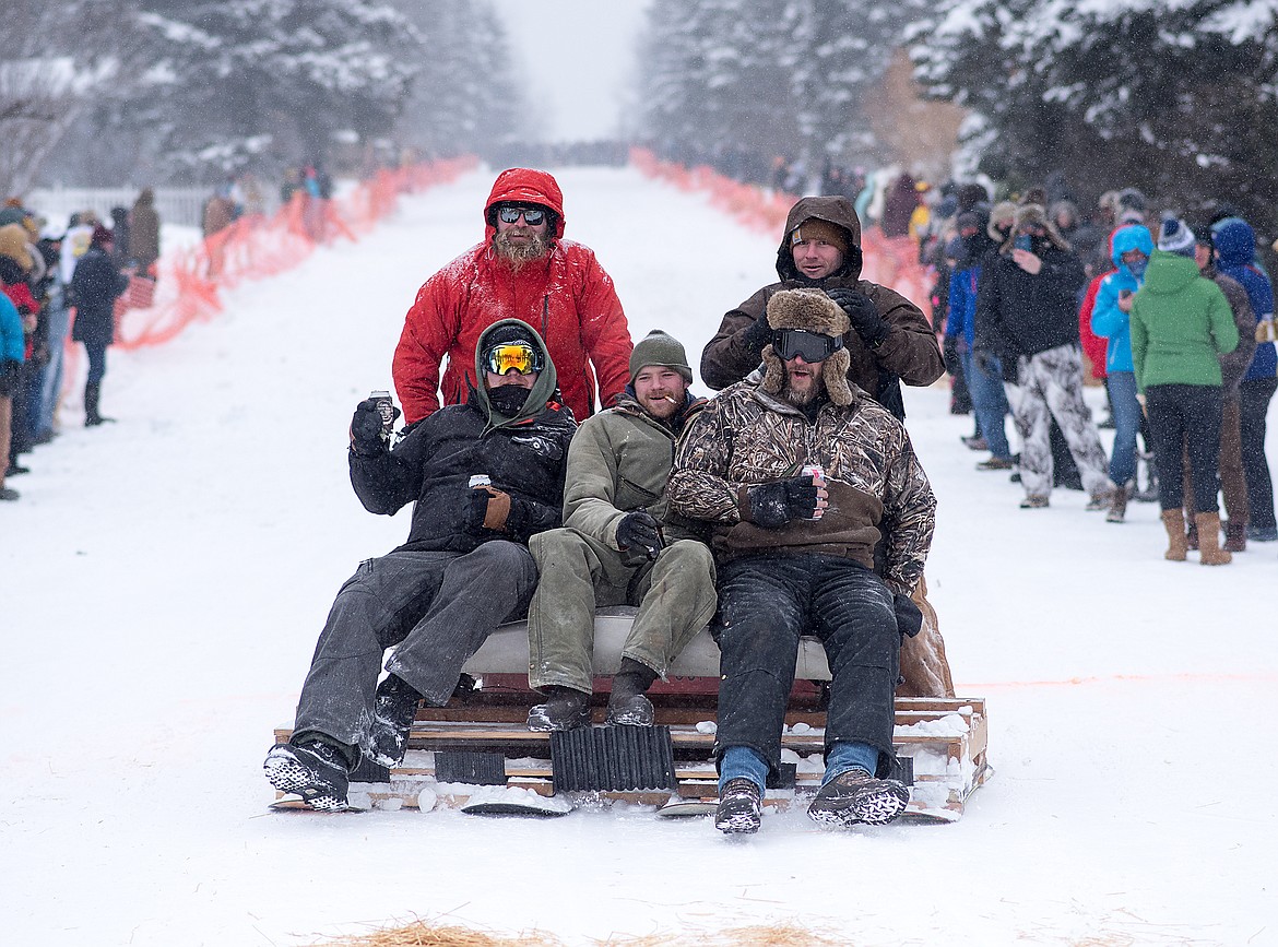 A back seat and four snowboards make for a comfy sled.