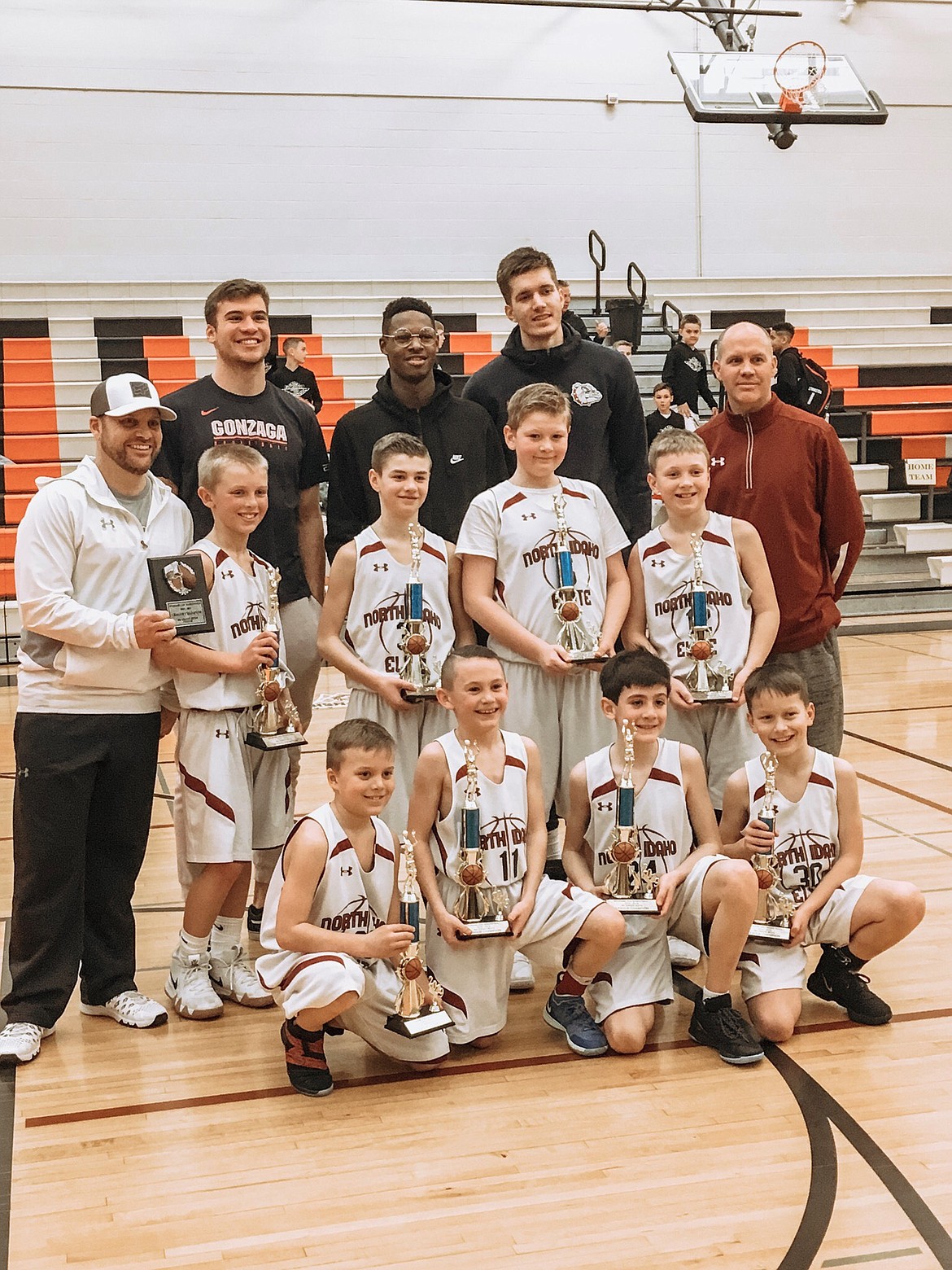 Courtesy photo
The North Idaho Elite fourth-grade boys basketball team won the Spokane AAU championship 66-22 over Built4 Ball at West Valley High School. NIE finished a perfect 12-0. In the front row from left are Maddox Lindquis, Brett Johnson, Wyatt Carr and Ben McElvany; second row from left, coach Mike Lindquist, Tanner Stern, Britton Johnston, Jordan Carlson, Jackson Hackett and coach Royce Johnston; and back row from left, Gonzaga Bulldogs Corey Kispert, Joel Ayayi and Filip Petrusev, there to support the AAU teams and hand out awards.