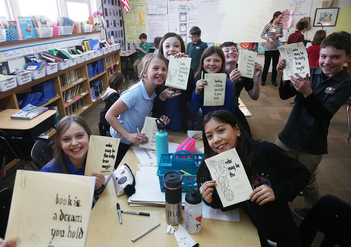 From left, fourth-grade students Hayden Montgomery, Zaria Metts, Ellie Moss, Abby Price, Irelynd Ford, Charlie Dircksen, and Brayden Smart show off their medieval manuscripts during a workshop with artist-in-residence Hannah Charlton at Sorensen Magnet School.

LOREN BENOIT/Press