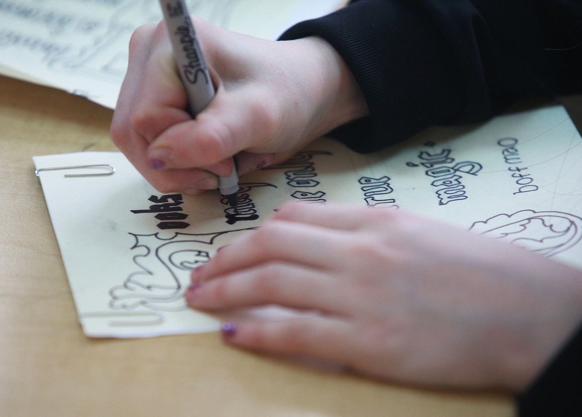 Fourth grade student Ellie Moss fills in her outlined manuscript during a workshop with artist-in-residence Hannah Charleton Tuesday afternoon at Sorensen Magnet School. The kids created medieval shapes and designs and learned how to make medieval letters. (LOREN BENOIT/Press)