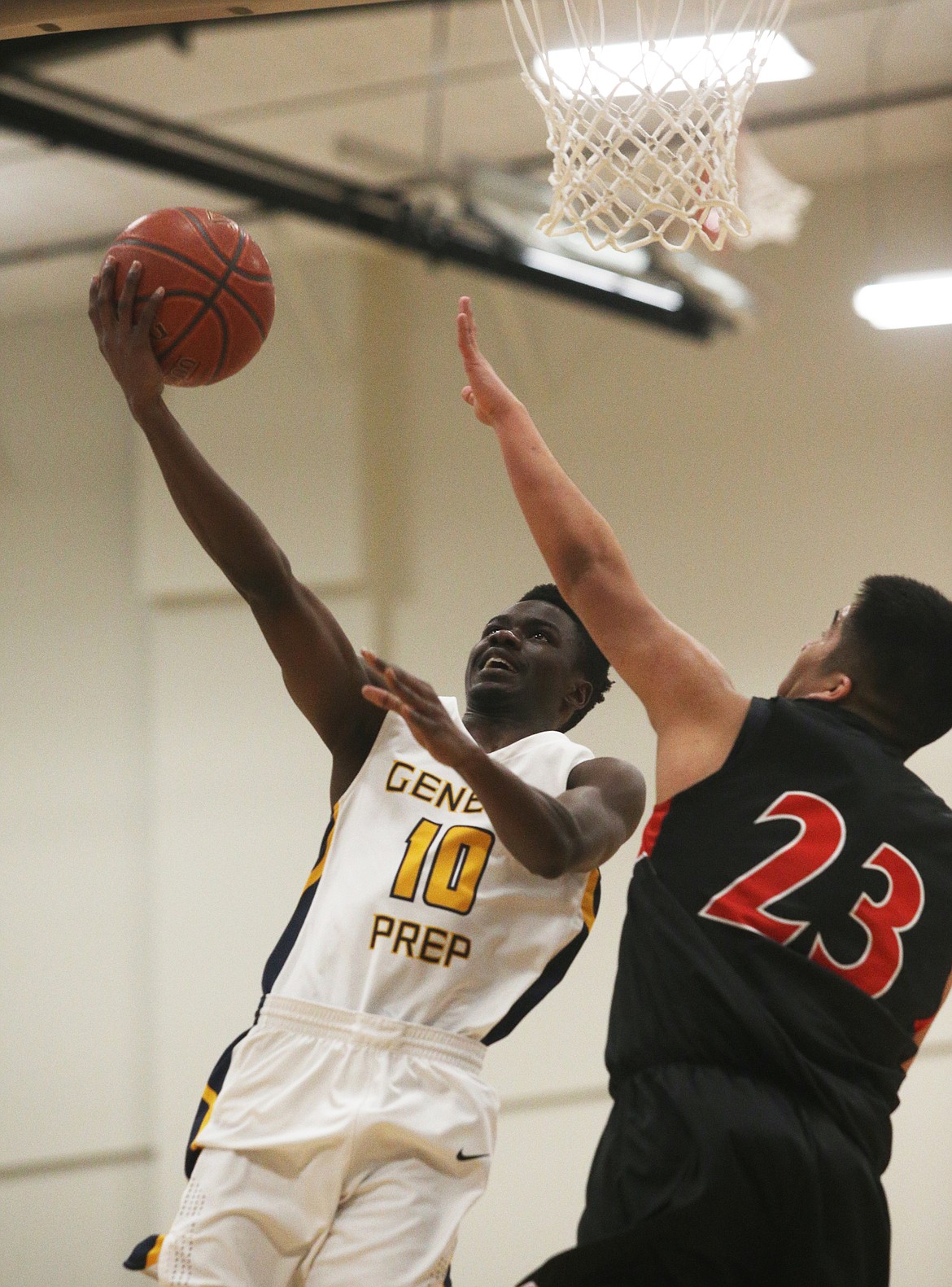 Scott Mwinuka of Genesis Prep goes for the layup while defended by Lakeside&#146;s Talon Twoteeth.