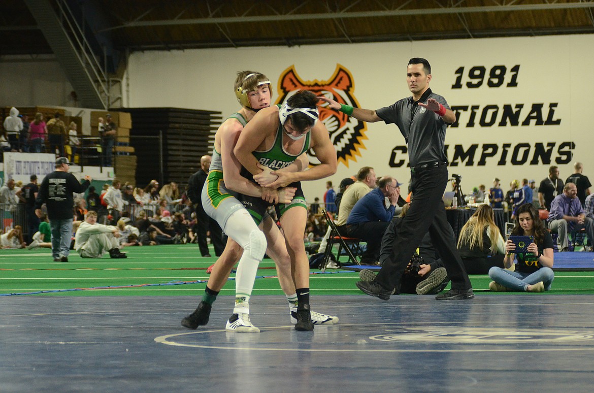 Photo by NORM and KELLY SEE
Sam Edelblute, left, of Lakeland, beat Esai Casteneda of Blackfoot by major decision, 15-6, in the 4A 126-pound finals Saturday at Holt Arena for his third state title.