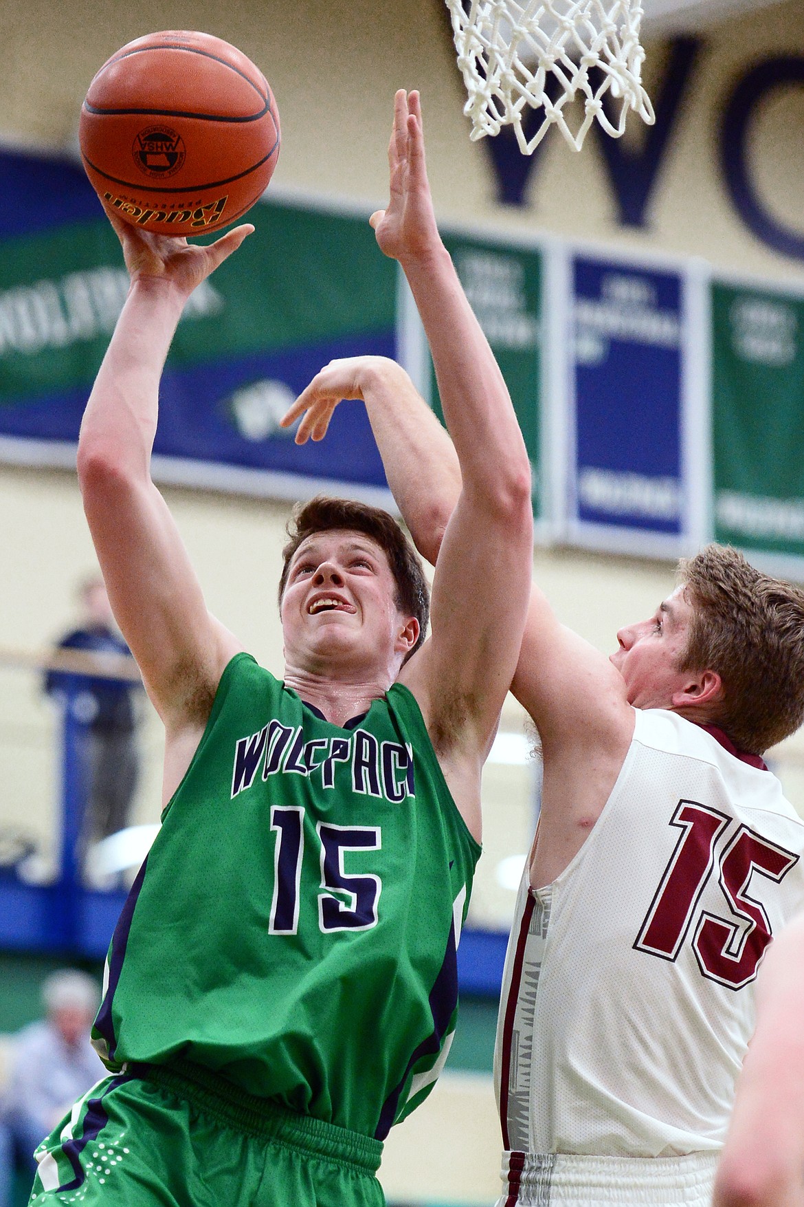 Glacier's Drew Engellant (15) drives to the hoop against Helena High's Hayden Ferguson (15) during Western AA Divisional play at Glacier High School on Thursday. (Casey Kreider/Daily Inter Lake)