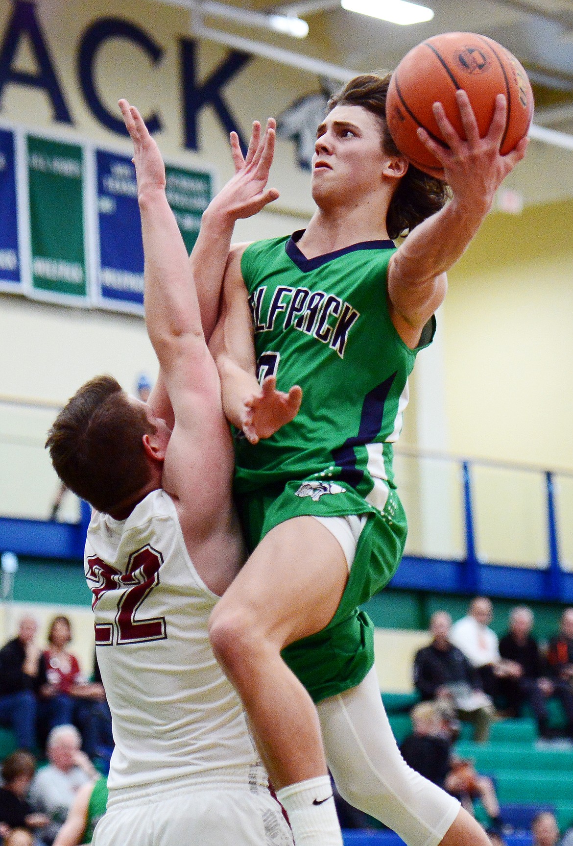 Glacier's Drew Deck (2) drives to the hoop against Helena High's Carson Woodland (22) during Western AA Divisional play at Glacier High School on Thursday. (Casey Kreider/Daily Inter Lake)