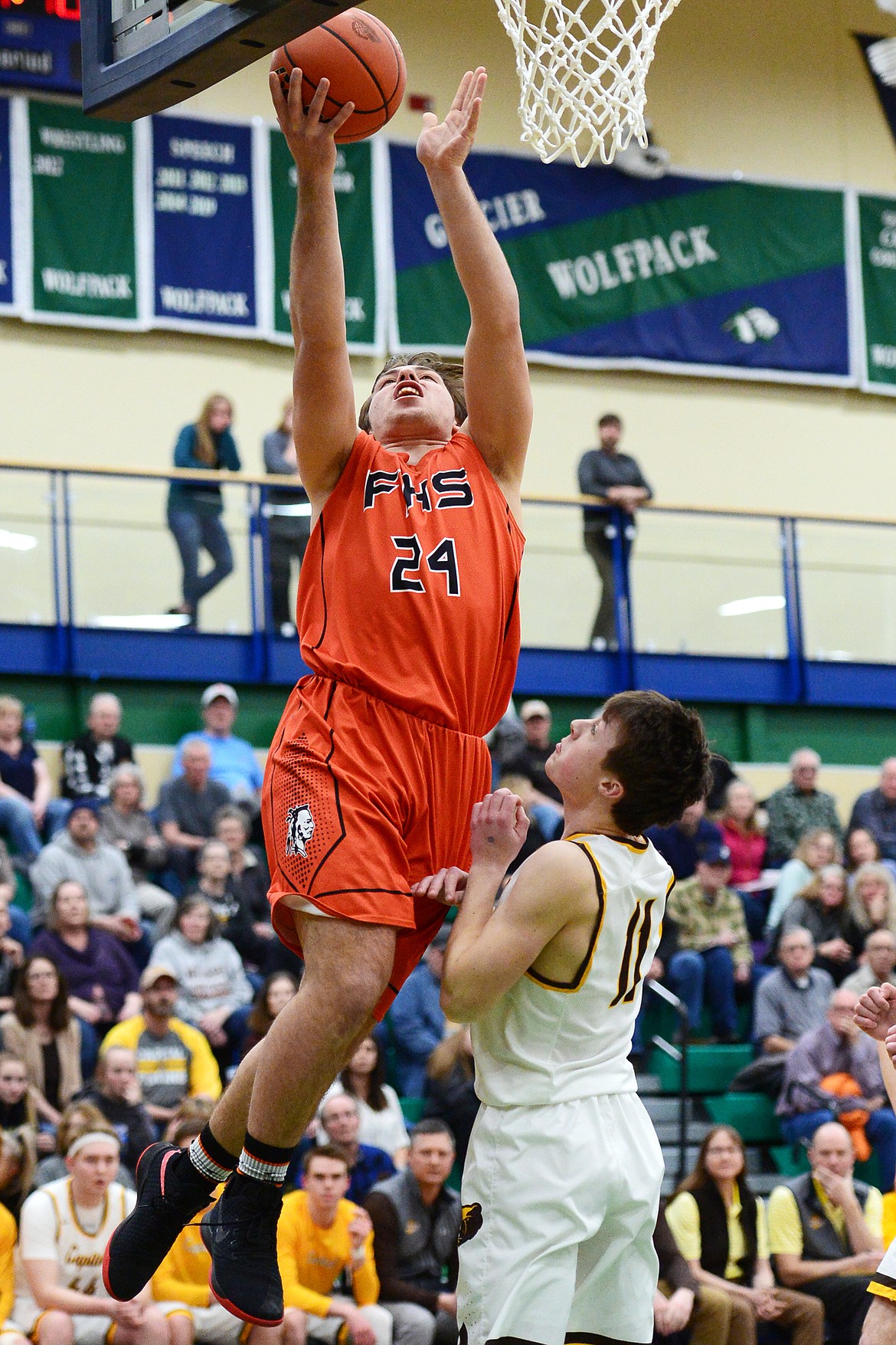 Flathead's Blake Counts (24) drives to the hoop against Helena Capital's Bridger Grovom (11) during Western AA Divisional play at Glacier High School on Thursday. (Casey Kreider/Daily Inter Lake)