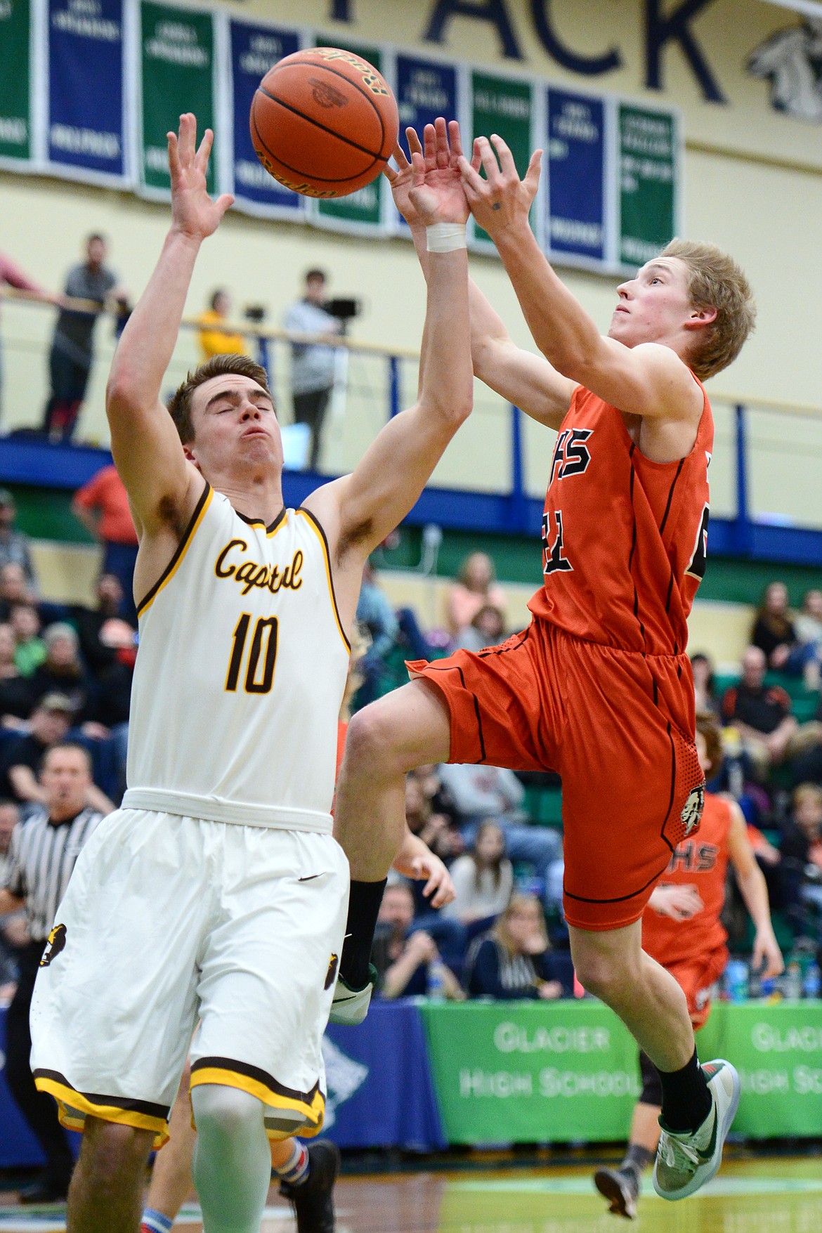 Flathead's Seth Moon (22) has the ball knocked loose by Helena Capital's Cade Kidder (10) during Western AA Divisional play at Glacier High School on Thursday. (Casey Kreider/Daily Inter Lake)