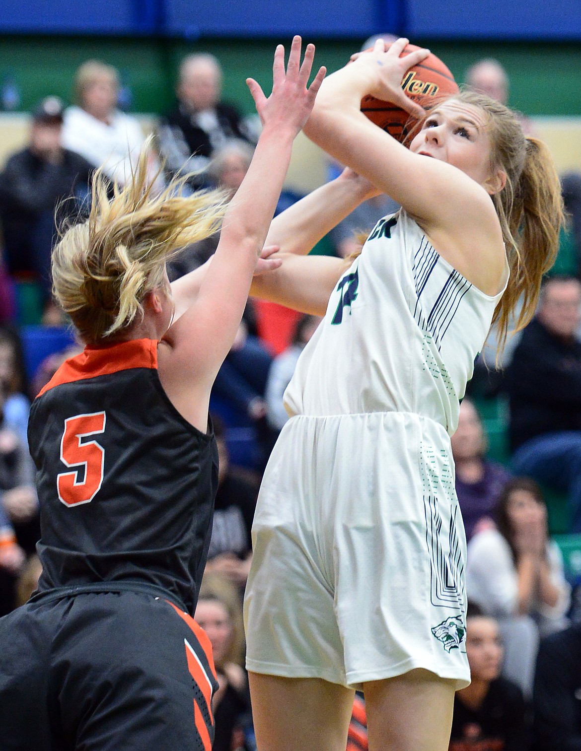 Glacier's Aubrie Rademacher (14) looks to shoot with Flathead's Maddie Walter (5) defending during Western AA Divisional play at Glacier High School on Thursday. (Casey Kreider/Daily Inter Lake)