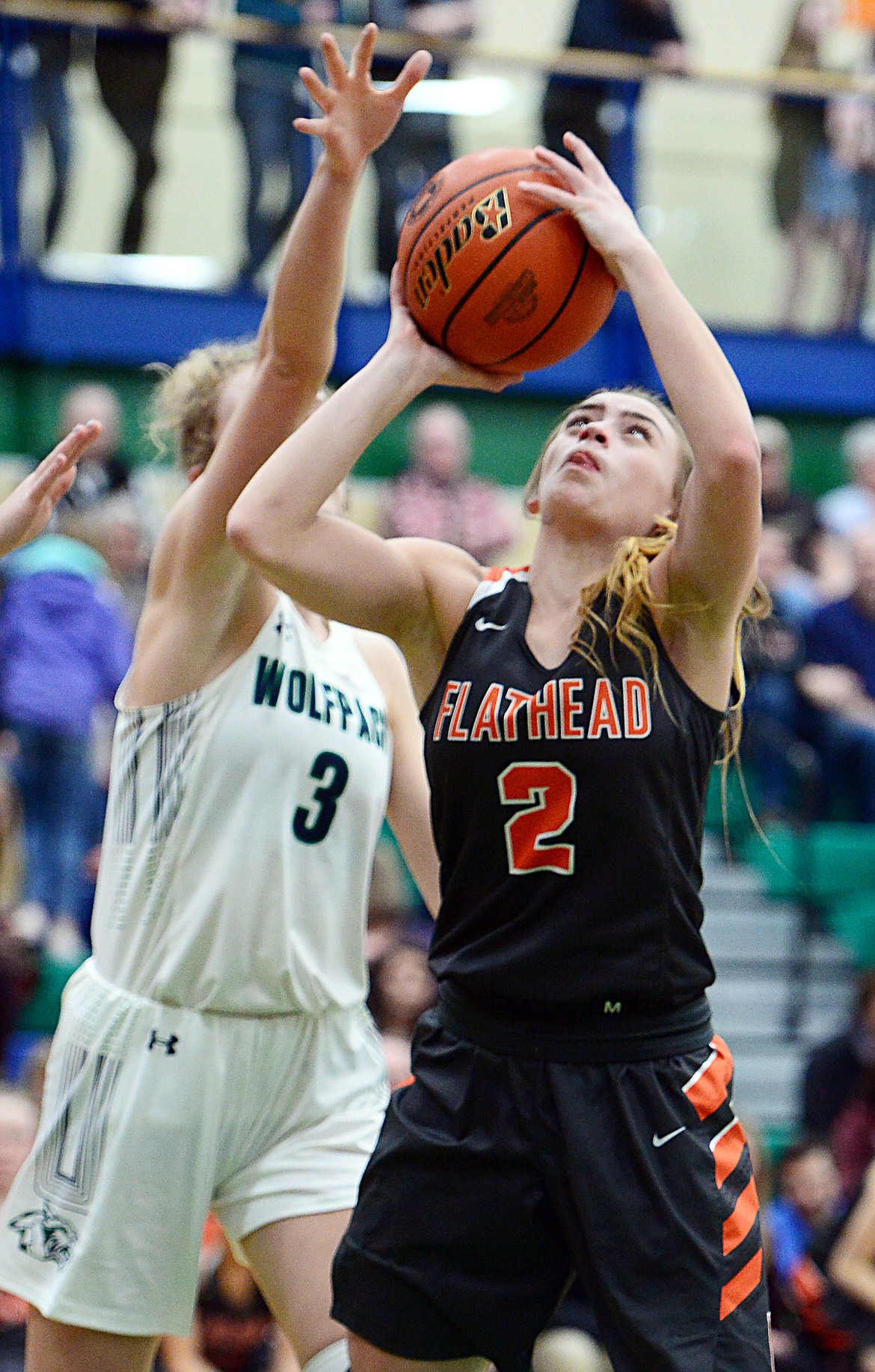 Flathead's Emily Lembke (2) looks to shoot under the basket with Glacier's Kali Gulick (3) defending during Western AA Divisional play at Glacier High School on Thursday. (Casey Kreider/Daily Inter Lake)