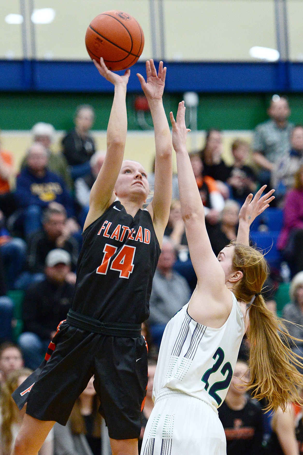 Flathead's Jenna Johnson (14) looks to shoot over Glacier's Ellie Keller (22) during Western AA Divisional play at Glacier High School on Thursday. (Casey Kreider/Daily Inter Lake)