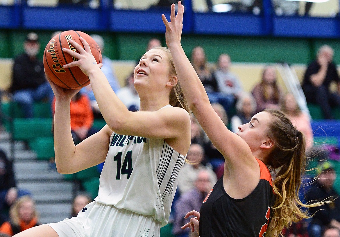 Glacier's Aubrie Rademacher (14) heads to the hoop after stealing the ball from Flathead's Emily Lembke (2) during Western AA Divisional play at Glacier High School on Thursday. (Casey Kreider/Daily Inter Lake)