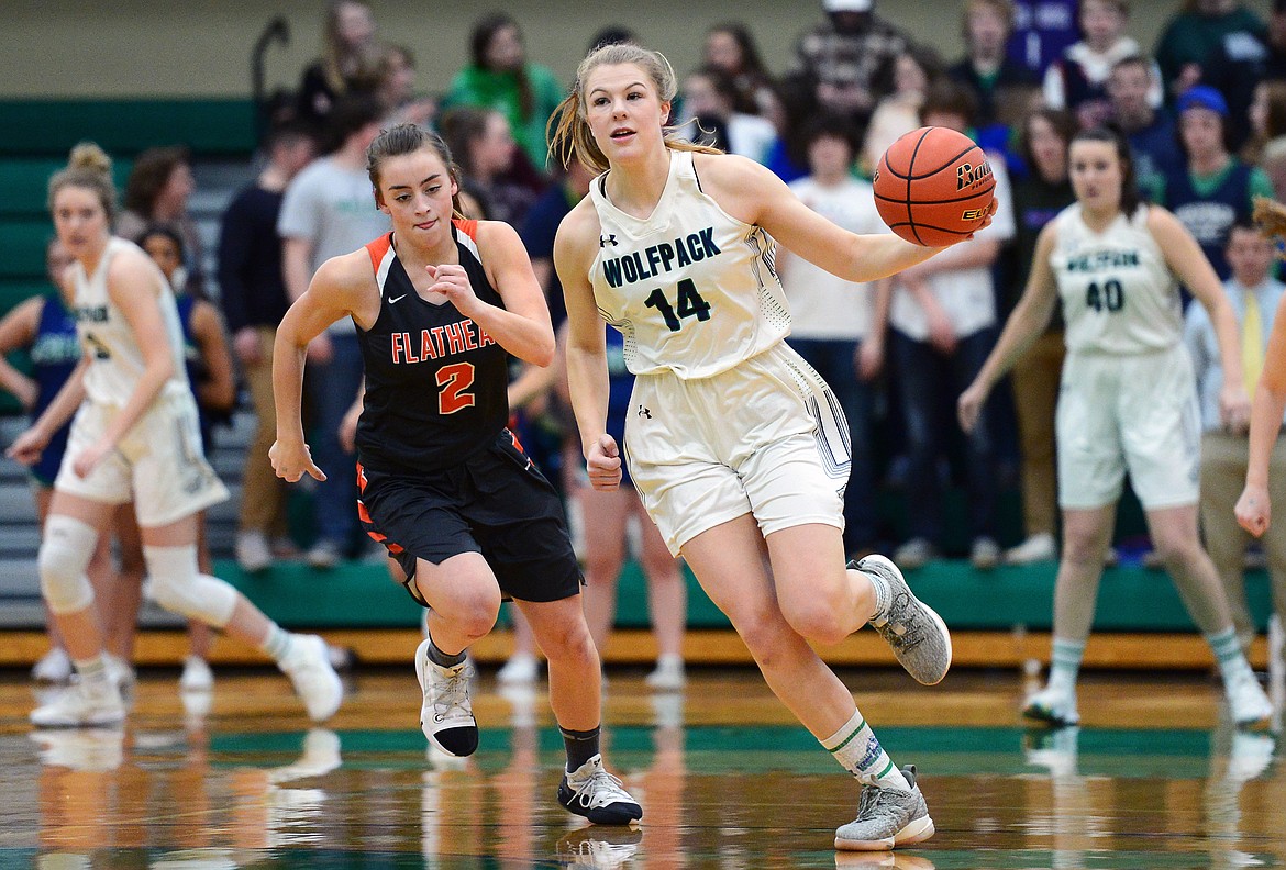 Glacier's Aubrie Rademacher (14) heads to the hoop after stealing the ball from Flathead's Emily Lembke (2) during Western AA Divisional play at Glacier High School on Thursday. (Casey Kreider/Daily Inter Lake)