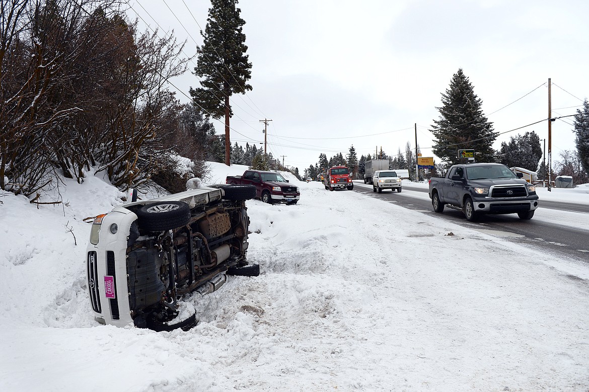 Scene of a rollover vehicle accident along U.S. 93 just north of Lakeside on Thursday. No injuries were reported. A quick shot of winter weather dropped a few inches of snow on the valley Thursday morning, creating hazardous driving conditions. More cold and snow is on the way this weekend. (Casey Kreider/Daily Inter Lake)