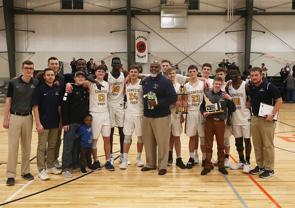 Genesis Prep players and staff pose with the 1A Division II District 1 championship trophy, and Buzz Lightyear, after defeating Lakeside 60-42 at The Courts. (LOREN BENOIT/Press)