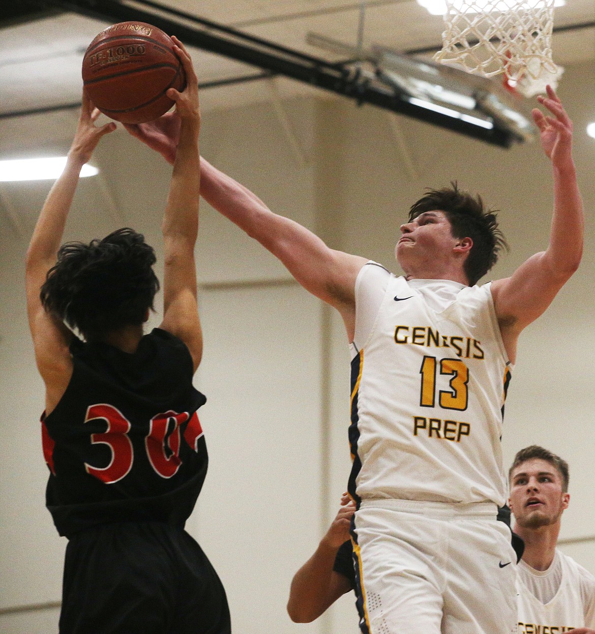 Jacob Schultz of Genesis Prep and Kenyon Spottedhorse of Lakeside fight for a rebound during Friday night&#146;s 1A Division II District 1 championship game at The Courts in Post Falls. (LOREN BENOIT/Press)