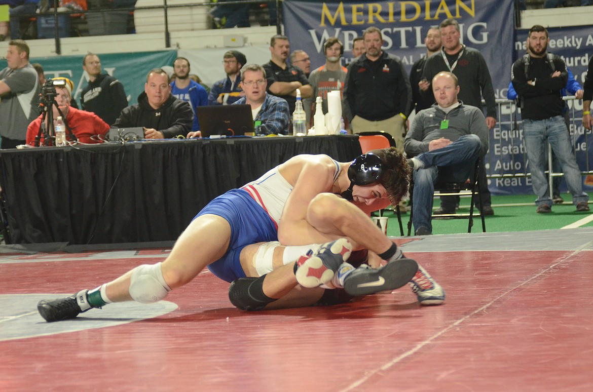 Photo by NORM and KELLY SEE
Coeur d&#146;Alene senior Mitchell Moffat pinned Cashe Olson of Centennial in 4:40 on Friday to advance to the 5A 160-pound semifinals.