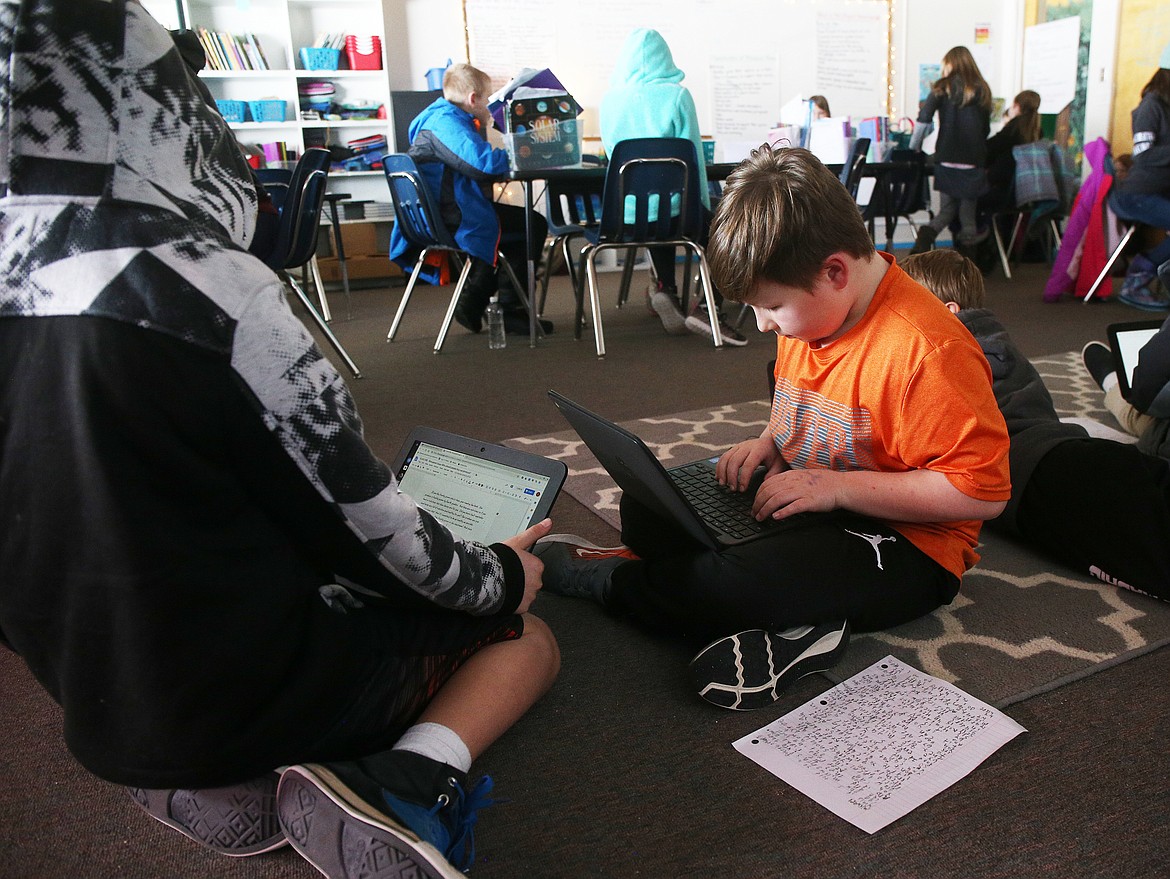 Fourth grade student Michael Jereczek types a persuasive letter during class Wednesday at Northwest Expedition Academy. (LOREN BENOIT/Press)