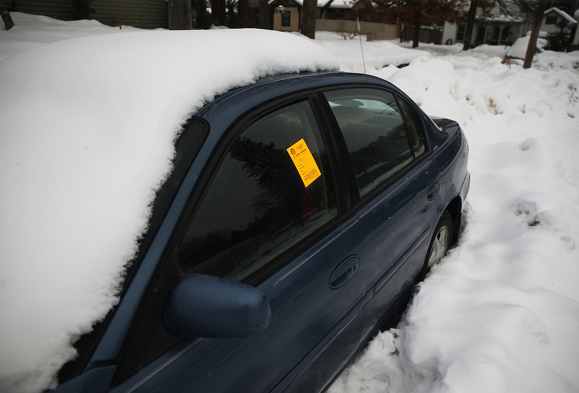 A 48-hour notice for removal is displayed on a car on Ninth Street and Mullan Avenue on Friday. (LOREN BENOIT/Press)