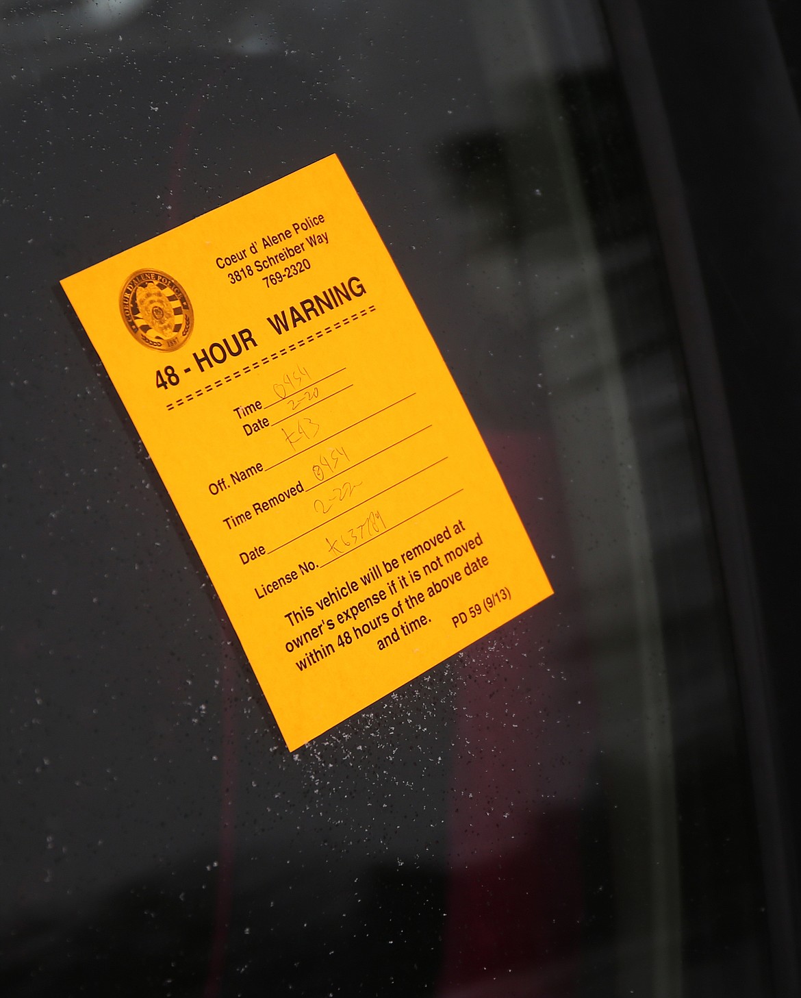 A 48-hour notice is displayed on a snowed in car on Ninth Street and Mullan Avenue. Coeur d&#146;Alene Police has tagged around 400 cars since Tuesday and will start towing them on Monday. (LOREN BENOIT/Press)