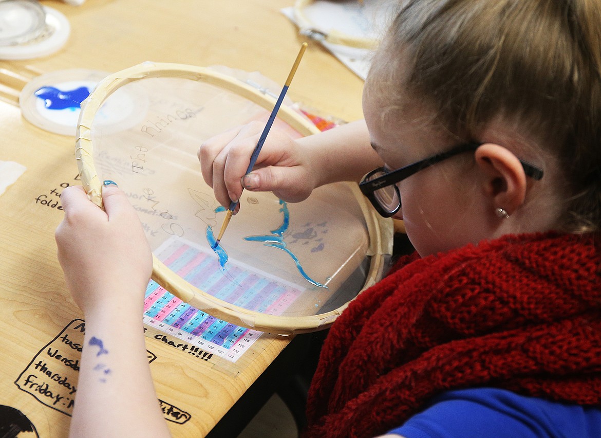 Fifth-grader Logan Hansen paints her design &#147;Save the Rhinos&#148; for a recyclable bag Thursday morning at Sorensen Magnet School.