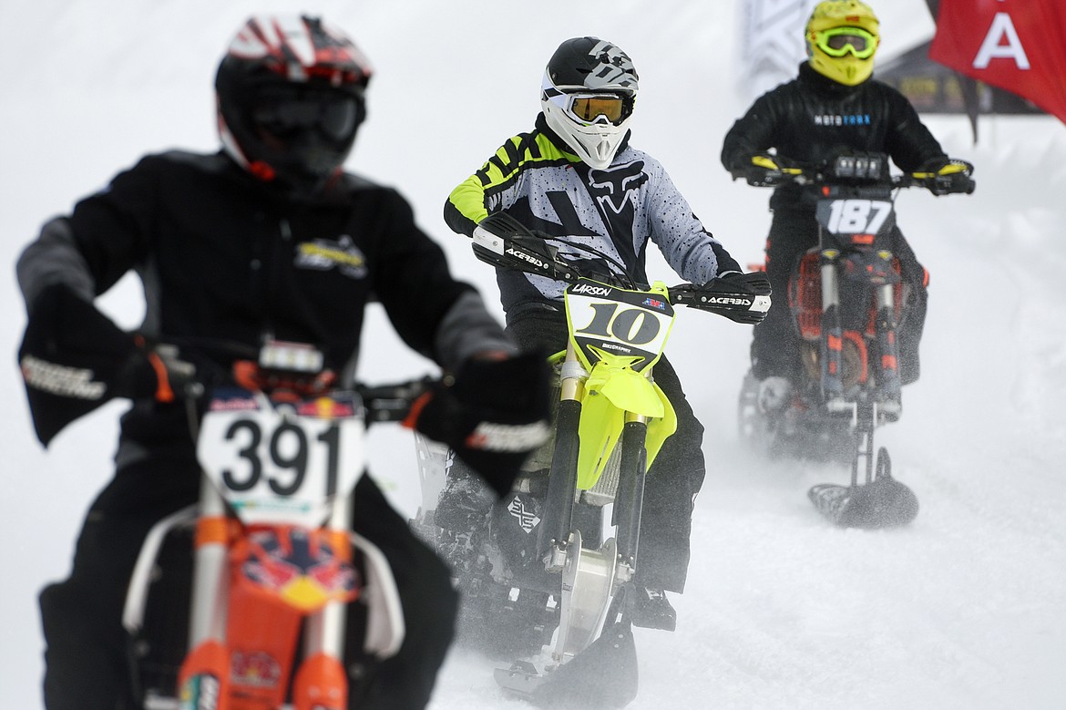 Snow bike racers take warm up laps prior to the start of Round 4 of the 509 National Championship Snow Bike Series race at the ATV park located at 6235 U.S. 93, north of Whitefish, on Saturday, Feb. 23. Racing action continues at 10 a.m. next Saturday, March 2, with the Montana Mayhem Offroad Racing Series Frostbite Frenzy ATV/UTV race. (Casey Kreider/Daily Inter Lake)