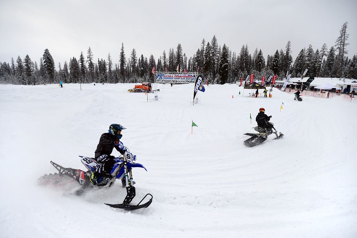 Snow bike racers take warm up laps prior to the start of Round 4 of the 509 National Championship Snow Bike Series race at the ATV park located at 6235 U.S. 93, north of Whitefish, on Saturday, Feb. 23. Racing action continues at 10 a.m. next Saturday, March 2, with the Montana Mayhem Offroad Racing Series Frostbite Frenzy ATV/UTV race. (Casey Kreider/Daily Inter Lake)