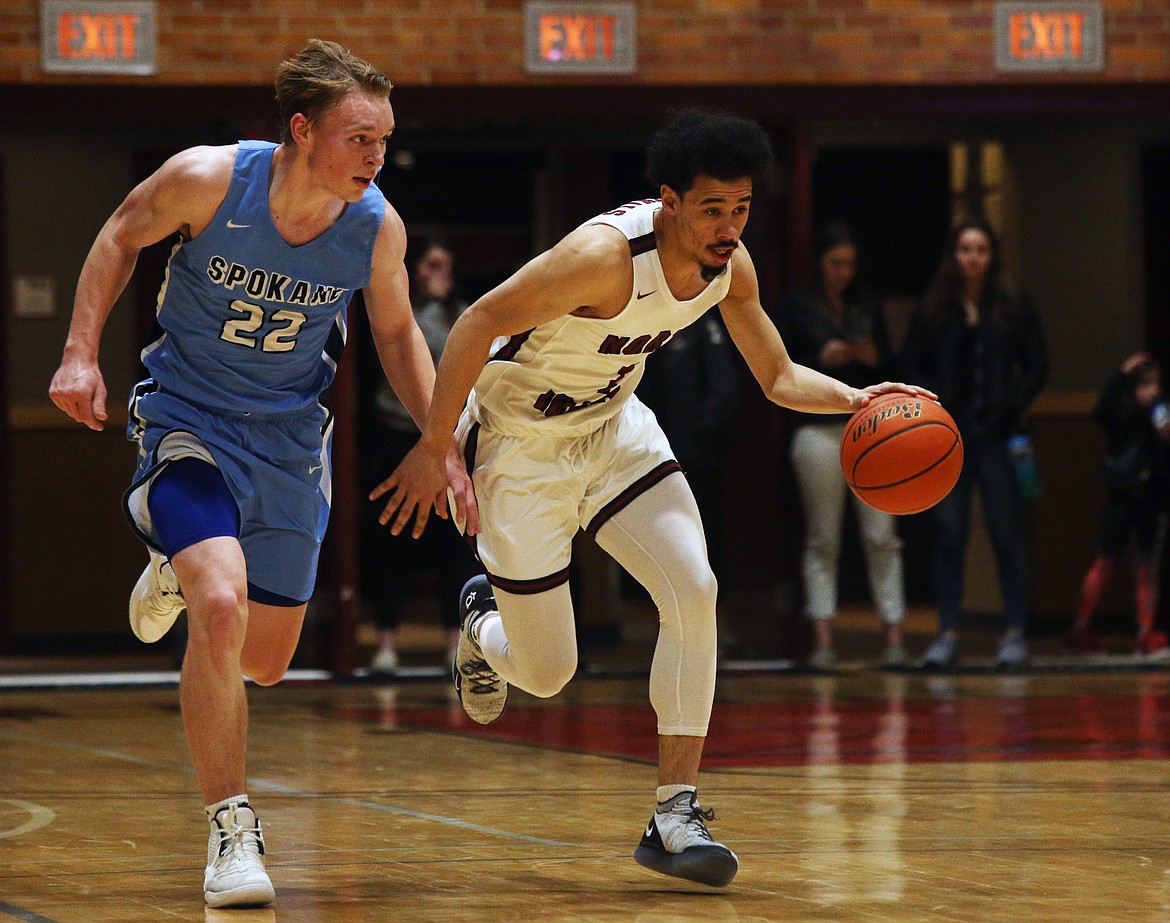 North Idaho College's Nate Pryor dribbles the ball down the court while defended by Community Colleges of Spokane's Garrett White. (LOREN BENOIT/Press)