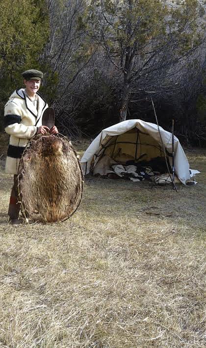 McQueen displays a tanned beaver hide from an animal he harvested with a trap he built. McQueen is wearing clothing he made representating the time period from 1800-1840, when mountain men were discovering the many treasures of the West.