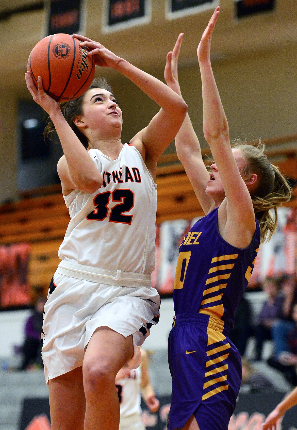 Flathead's Taylor Henley (32) drives to the hoop against Missoula Sentinel's Brooke Stayner (30) at Flathead High School on Thursday. (Casey Kreider/Daily Inter Lake)