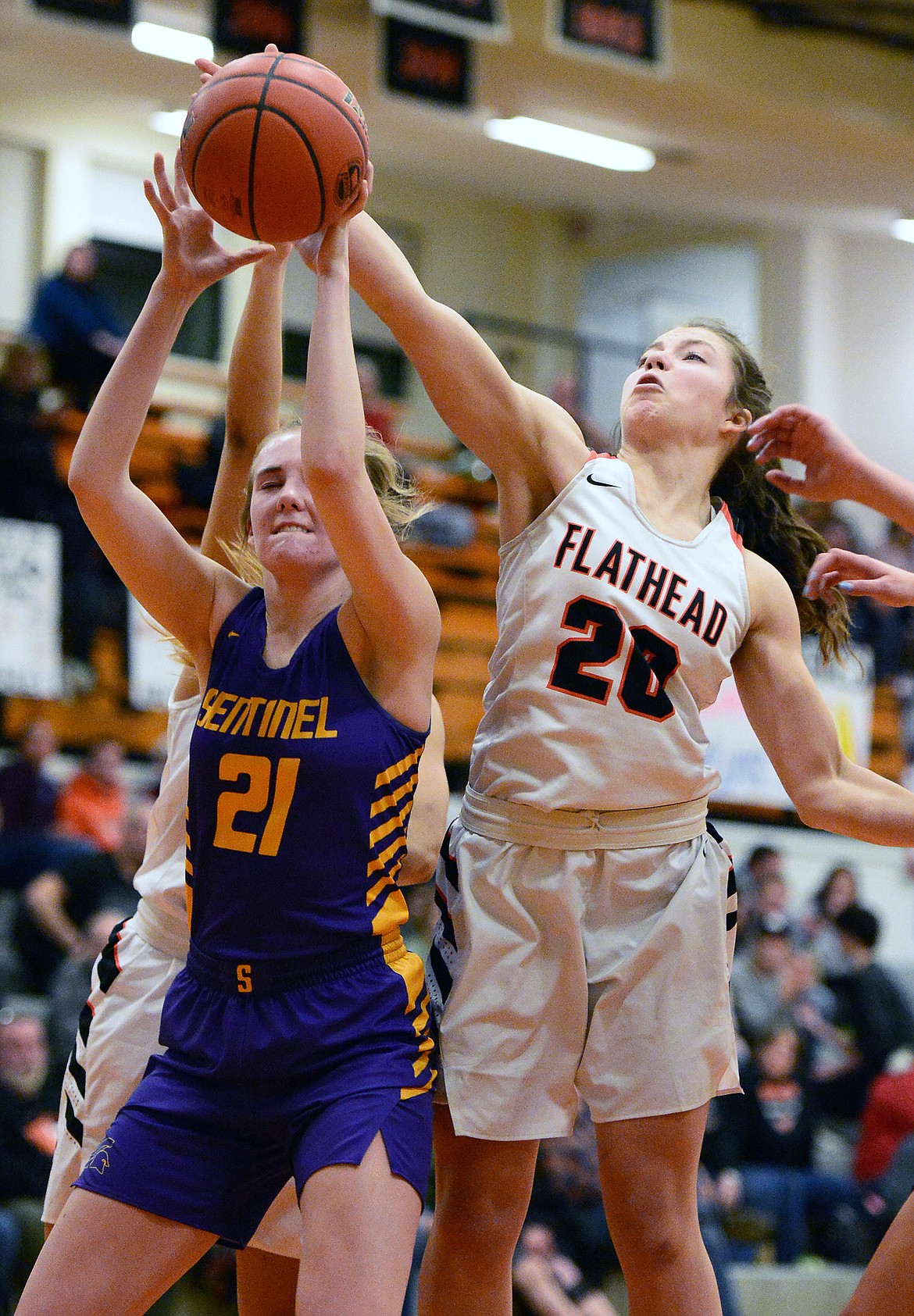 Flathead's Bridget Crowley (20) battles for a rebound with Missoula Sentinel's Challis Westwater (21) at Flathead High School on Thursday. (Casey Kreider/Daily Inter Lake)