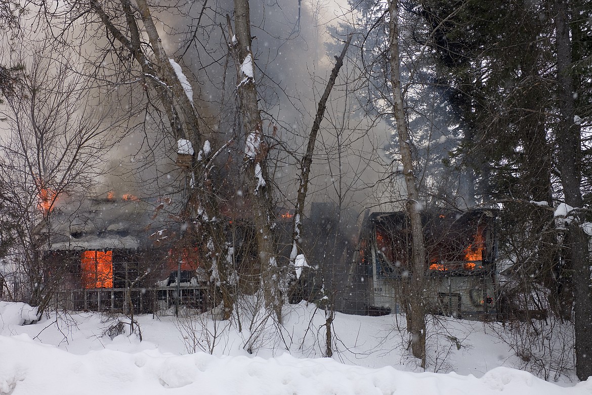 Firefighters from Hungry Horse-Martin City and Bad Rock battled a house fire Thursday off Central Avenue. The house was completely engulfed when the call came in. (Chris Peterson photo)