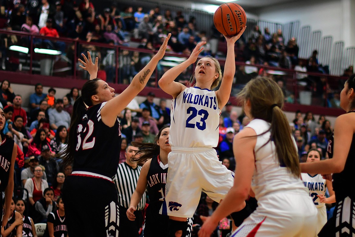 Ryley Kehr pulls up for a jumper in the lane over Brownings Taylor Jordan in the second quarter of the Western A Divisional title game Saturday. Kehr averaged 19 points per game at the tournament to lead the Kats. (Jeremy Weber photo)