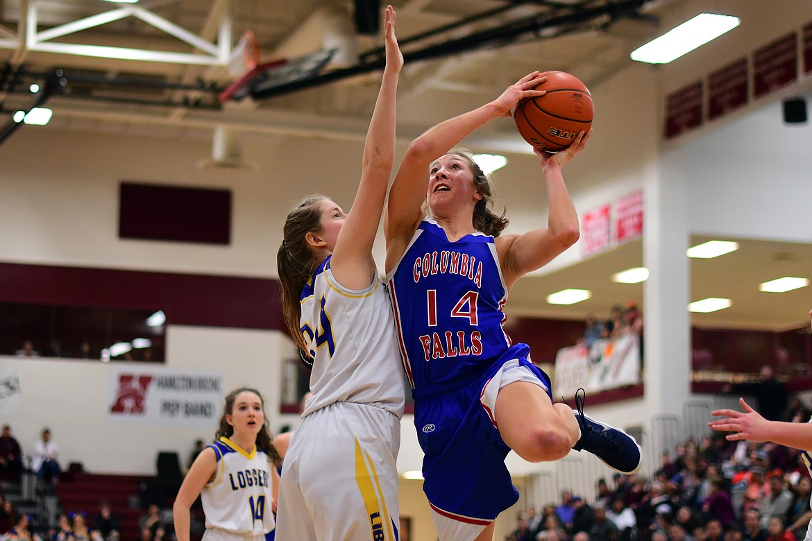 Josie Windauer goes up for a tough shot over Libby&#146;s McKenzie Profitt Friday. (Jeremy Weber photo)