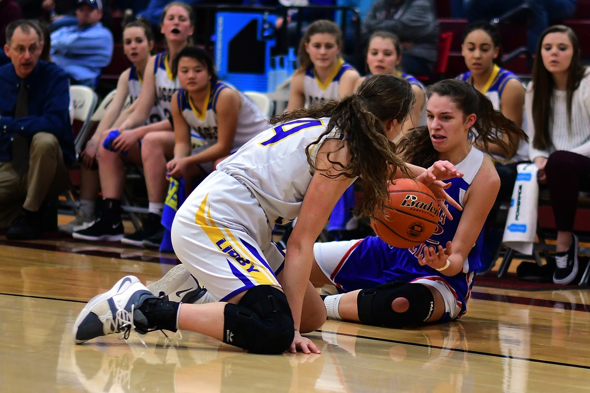 Madysen Horner battles Libby&#146;s Jayden Winslow for lose ball in the second quarter. (Jeremy Weber photo)