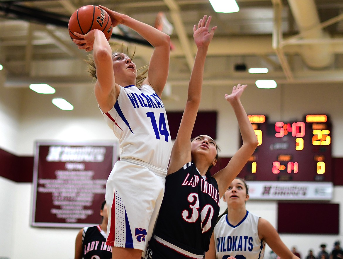 Josie Windauer goes up over Browning&#146;s Dulci Skunkcap for two of her team-high 16 points against the Lady Indians Saturday. (Jeremy Weber photo)