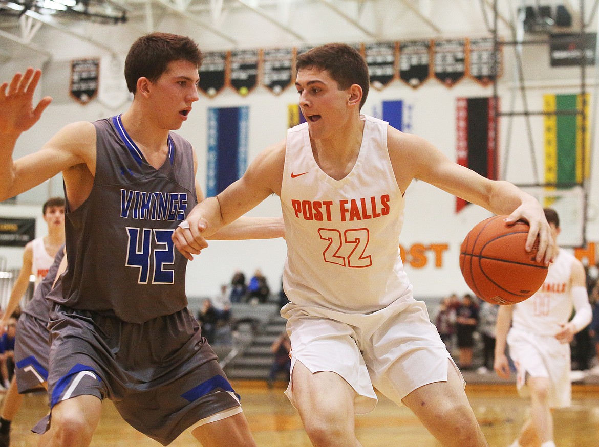 Gavven Desjarlais of Post Falls High dribbles the ball towards the basket while defended by Coeur d&#146;Alene&#146;s Kale Edwards. (LOREN BENOIT/Press)