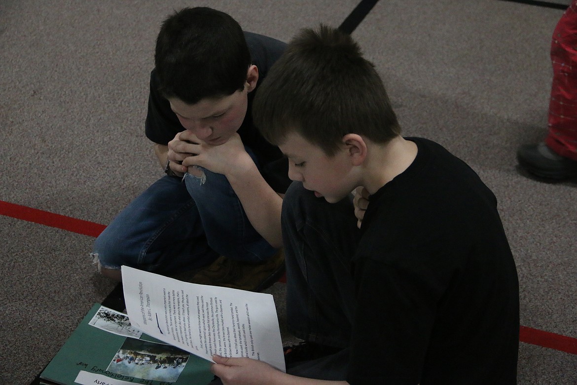 (Photo by MARY MALONE)
Idaho Hill Elementary fifth graders Cody Willis and Aden Thompson read to each other from the writings they did in class during the school&#146;s writing challenge assembly on Friday.