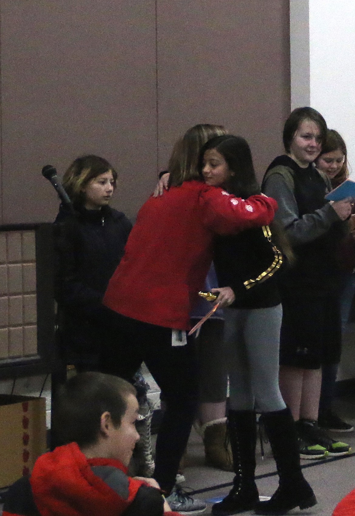 (Photo by MARY MALONE)
Idaho Hill Elementary sixth-grader Athena Welker won a special trophy and a hug from her teacher during Friday&#146;s second-quarter awards ceremony.