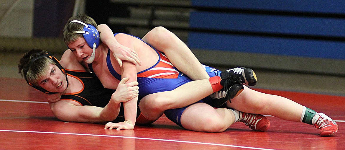LEVI BLOOD of the Plains/Hot Springs (black singlet), above, works to get a reversal on Carter McLees of Clark Fork during the first Little Guy Wrestling competition of the season at the Superior Mixer last Thursday.
