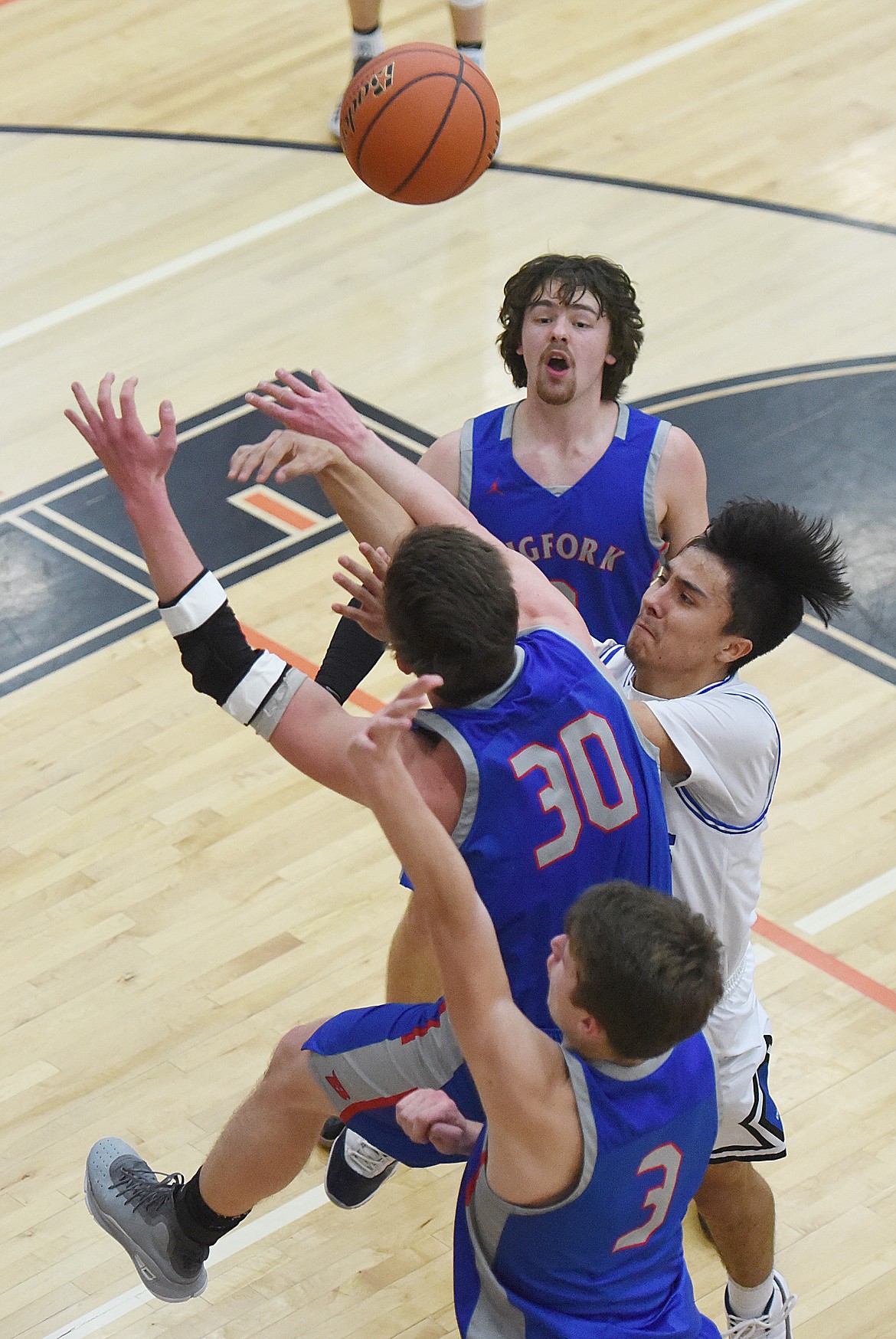 JACOB HUGS of Mission shoots over Logan Gilliard of Bigfork during last Friday&#146;s semifinals of the Western B Divisional Tournament in Ronan. Hugs netted 20 points to lead the Bulldogs. After the loss, Mission beat Florence-Carlton and Deer Lodge to earn a challenge game berth. (Joe Sova/Lake County Leader)